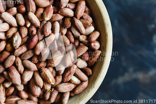 Image of Roasted peanuts in wooden bowl