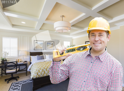 Image of Contractor in Hard Hat Over Custom Bedroom Drawing and Photo