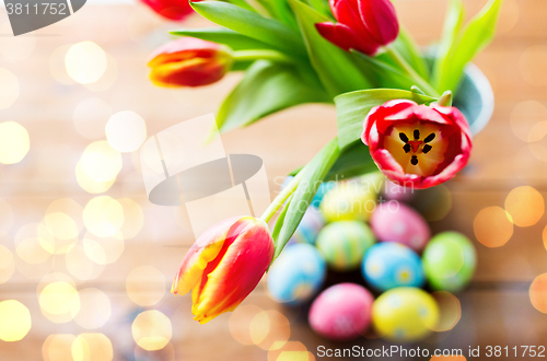 Image of close up of easter eggs and flowers in bucket