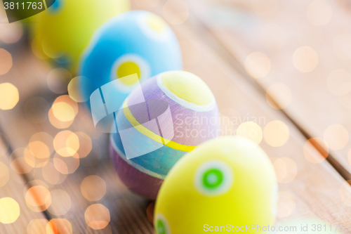 Image of close up of colored easter eggs on wooden surface