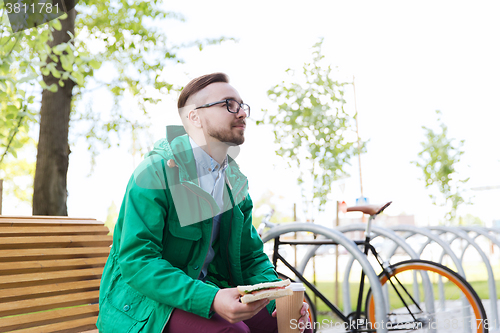 Image of happy young hipster man with fixed gear bike