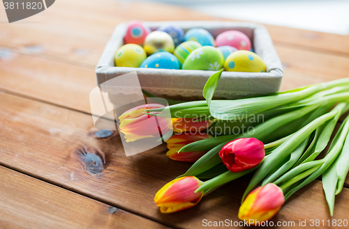 Image of close up of colored easter eggs and flowers