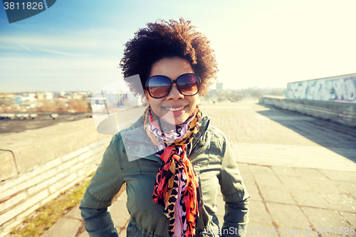 Image of happy african american woman in shades on street