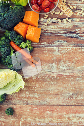 Image of close up of ripe vegetables on wooden table