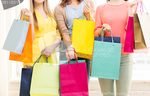 Image of close up of happy teenage girls with shopping bags