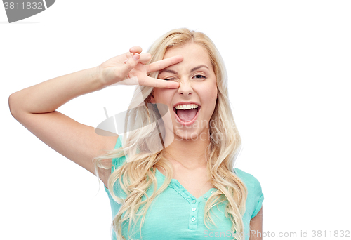 Image of smiling young woman or teenage girl showing peace