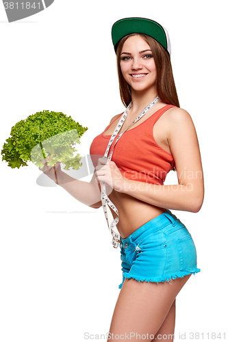 Image of Teen girl with measurement tape holding lettuce