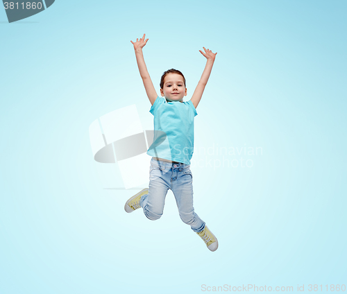 Image of happy little girl jumping in air over blue
