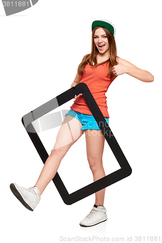 Image of Teen funky girl standing with a frame