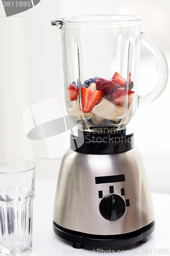 Image of close up of blender shaker with fruits and berries