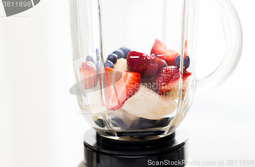 Image of close up of blender shaker with fruits and berries