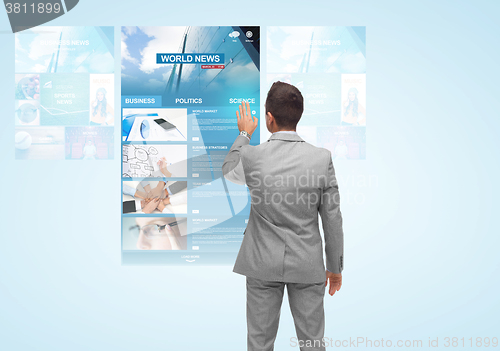 Image of man with virtual projection of business news