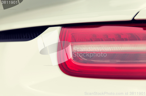 Image of close up of car part with grille and headlight