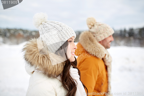 Image of happy couple walking over winter background