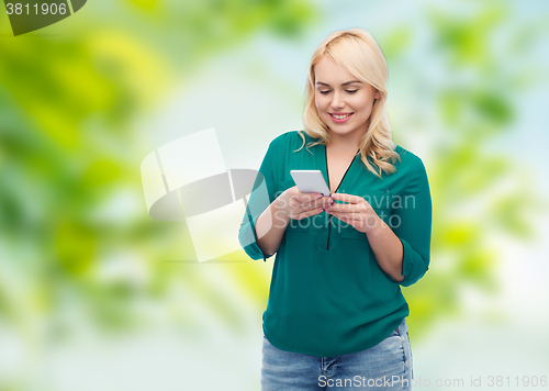 Image of happy woman with smartphone texting message