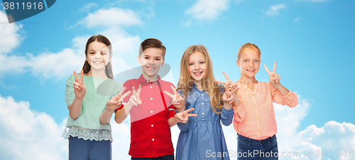 Image of happy boy and girls showing peace hand sign