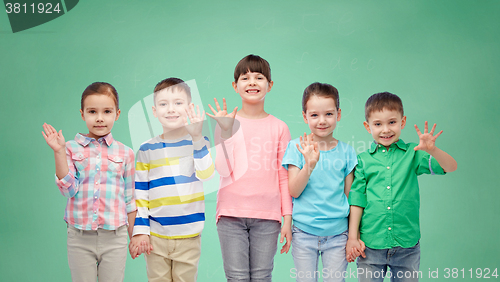 Image of happy smiling little children holding hands