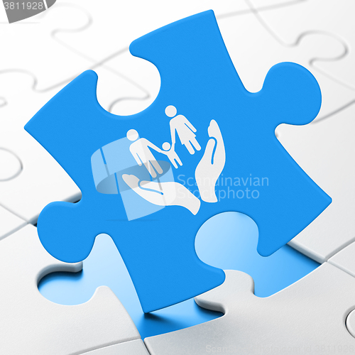 Image of Insurance concept: Family And Palm on puzzle background