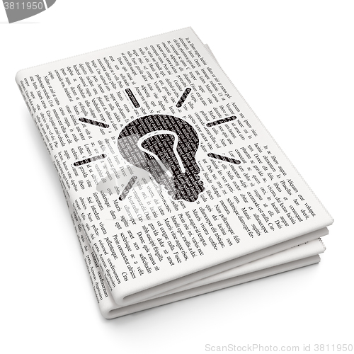 Image of Finance concept: Light Bulb on Newspaper background
