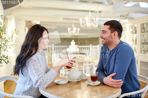 Image of happy couple drinking tea at cafe