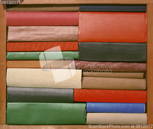 Image of Old books on wooden brown shelf