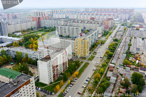 Image of Aerial view on city street, houses and garages