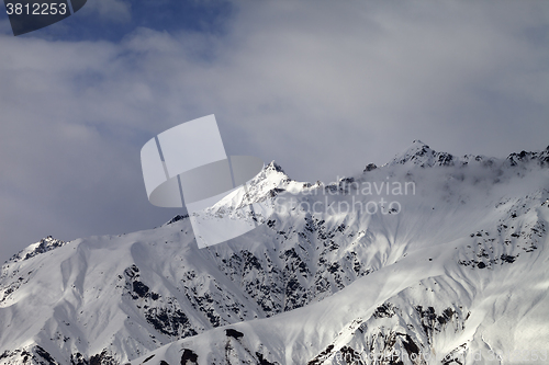 Image of Sunlight mountain peak and cloudy sky in evening