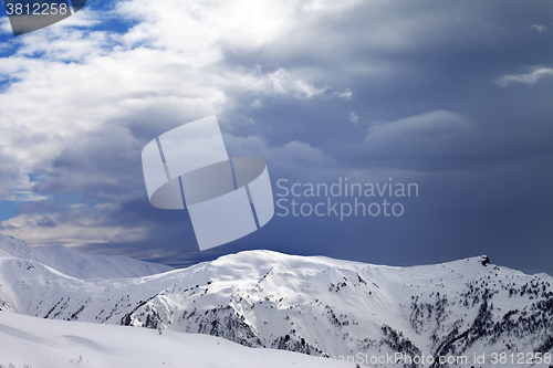 Image of Sunlight slope and cloudy gray sky in evening