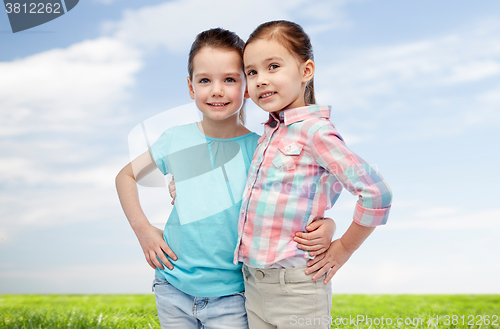 Image of happy smiling little girls hugging