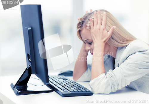 Image of stressed woman with computer