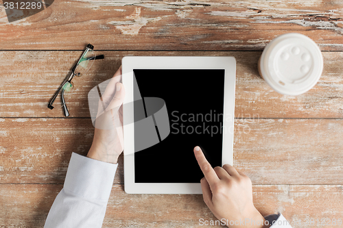 Image of close up of female hands with tablet pc and coffee