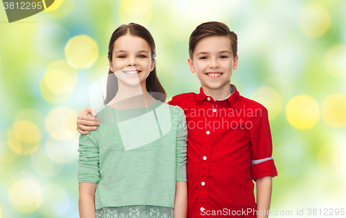 Image of happy boy and girl hugging over green lights