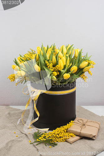 Image of Bright spring bouquet of tulips and mimosa flowers