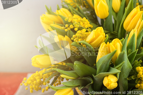 Image of Bright spring bouquet of tulips and mimosa flowers