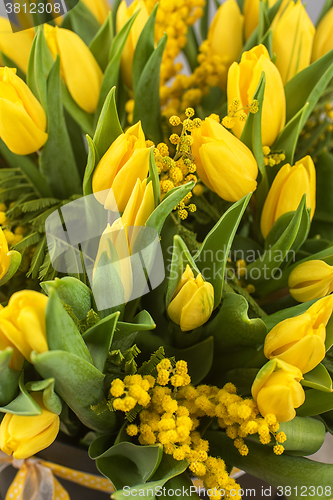 Image of Bright spring bouquet of tulips and mimosa flowers