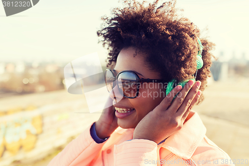 Image of happy young woman in headphones listening to music