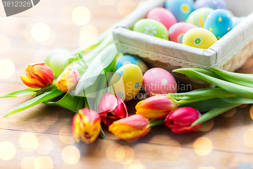 Image of close up of colored easter eggs and flowers