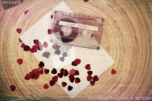 Image of Audio cassette tape on red backgound with fabric heart