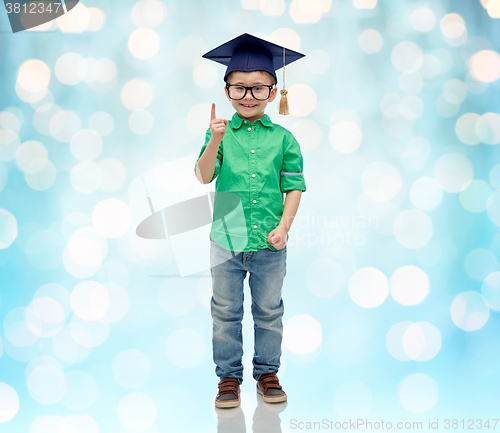 Image of happy boy in bachelor hat and eyeglasses