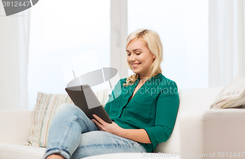 Image of smiling woman with tablet pc at home