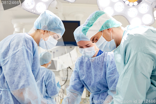 Image of group of surgeons in operating room at hospital