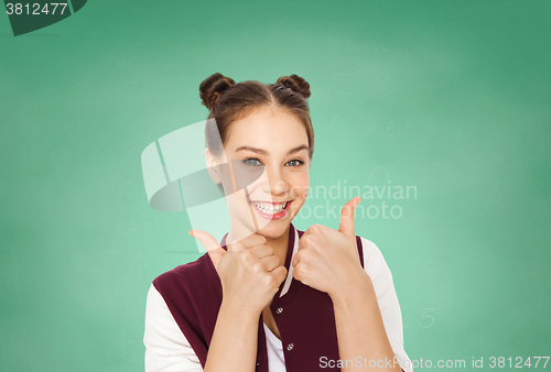 Image of happy teenage student girl showing thumbs up