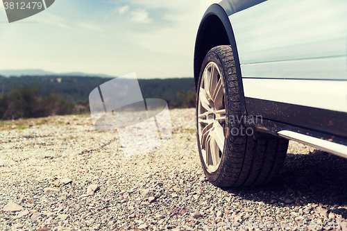 Image of close up of dirty car wheel on cliff