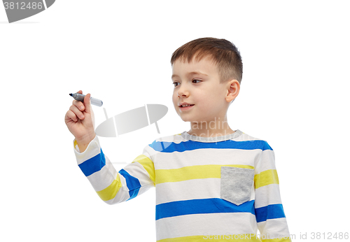 Image of little boy drawing or writing with marker