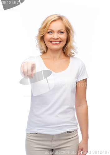 Image of smiling woman in white t-shirt pointing to you