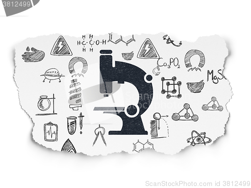Image of Science concept: Microscope on Torn Paper background
