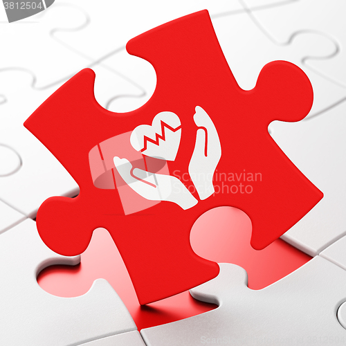 Image of Insurance concept: Heart And Palm on puzzle background