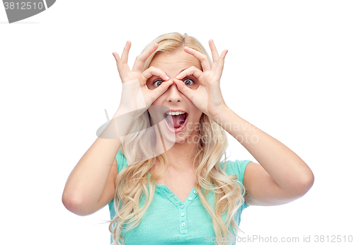 Image of young woman looking through finger glasses