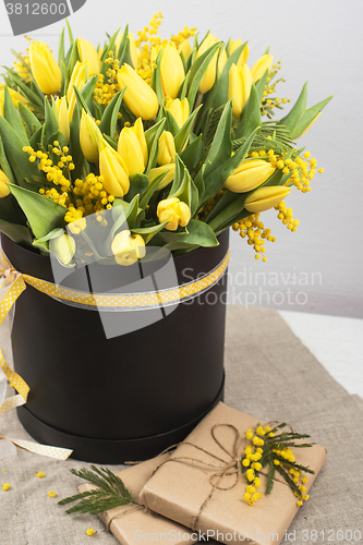 Image of Bright spring bouquet of tulips and mimosa flowers