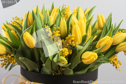 Image of Bright spring bouquet of tulips and mimosa flowers